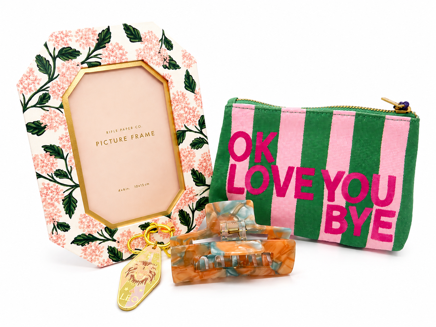 A grouping of 4 gifts chosen for the Leo zodiac sign: a picture frame, a pouch bag, a claw clip, and a Leo metal keychain.